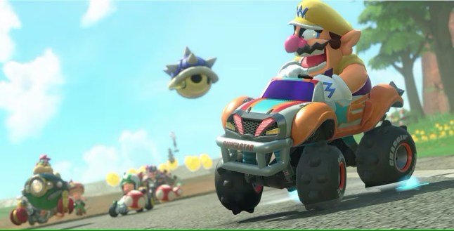 Mario Kart World screenshot with Wario in a car and a blue shell