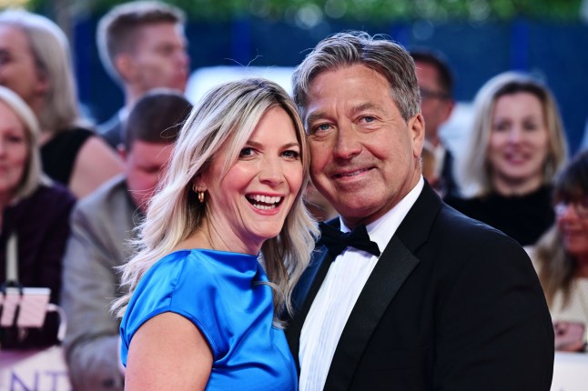 Lisa Faulkner and John Torode smile on the red carpet at the National Television Awards in 2024.