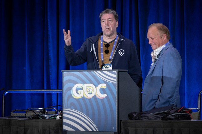 Julian LeFay and Ted Peterson on stage giving a speech at GDC 2024