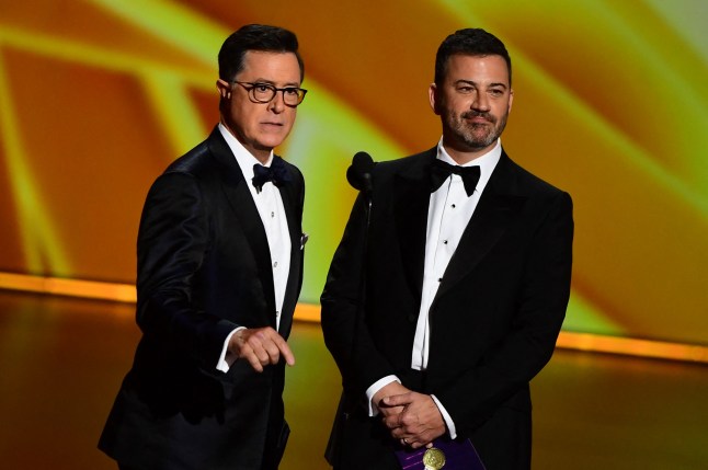 Stephen Colbert (L) and Jimmy Kimmel speak onstage during the 71st Emmy Awards at the Microsoft Theatre in Los Angeles on September 22, 2019. (Photo by Frederic J. BROWN / AFP) (Photo by FREDERIC J. BROWN/AFP via Getty Images)