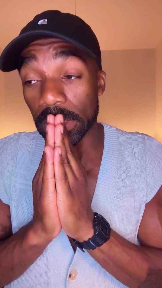 Ore Oduba with his hands clapped together looking concerned