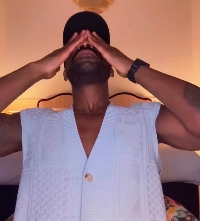 Ore Oduba with his hands wiping his eyes