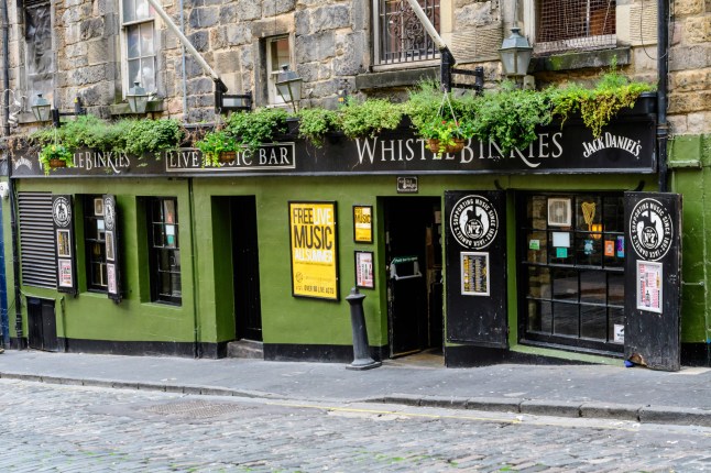 Edinburgh, Scotland, 11 June 2019: Main entry to Whistle Binkies Live Music Bar in a cloudy rainy summer day