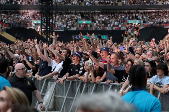 Editorial use only - no use after July 24 2026. Liam and Noel Gallagher from Oasis play Wembley stadium in the rocker's first reunion gig in London. The first 2,000 fans to arrive today with standing tickets got upgraded to an entrance giving them priority to get to the front first. Photo released 25/07/2025