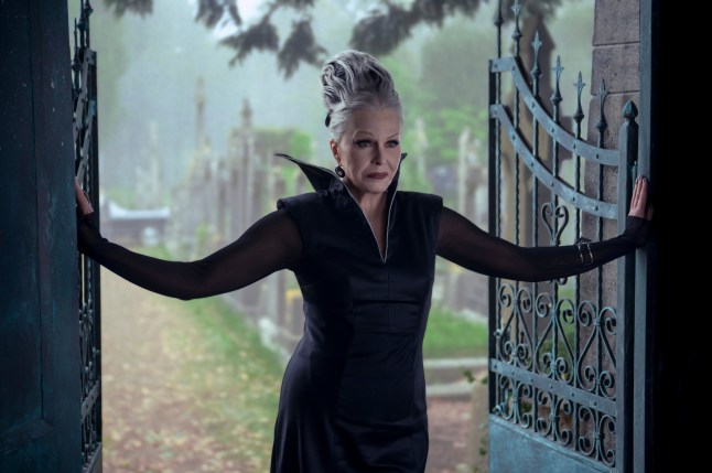 Joanna Lumley as Grandmama in Wednesday season two, wearing a black dress and stood in a doorway.