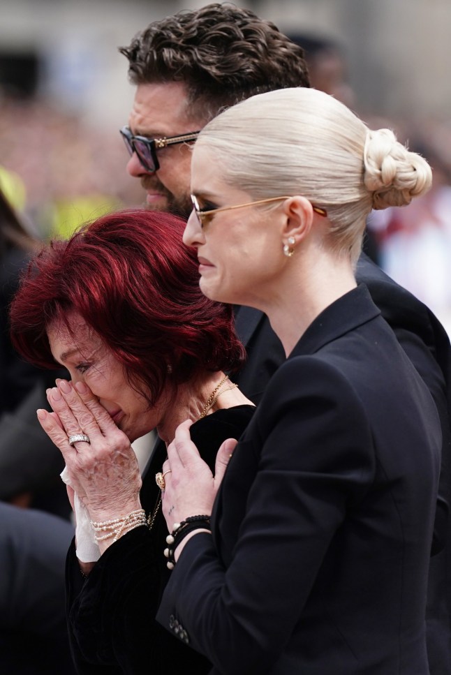 The family of Ozzy Osbourne (left to right) Jack Osbourne, Sharon Osbourne and Kelly Osbourne lay flowers and view the messages and floral tributes left at the Black Sabbath Bridge bench on Broad Street in Birmingham in memory of Black Sabbath frontman Ozzy Osbourne, as his body is brought back to his home city for a procession following his death last week aged 76. Picture date: Wednesday July 30, 2025. PA Photo. Photo credit should read: Jacob King/PA Wire