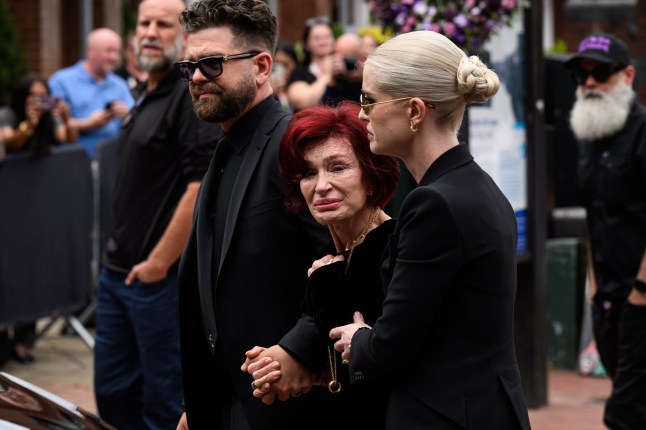 BIRMINGHAM, ENGLAND - JULY 30: (L-R) Jack Osbourne, Sharon Osbourne and Kelly Osbourne leave after viewing tributes to the late Ozzy Osbourne from fans as his funeral cortege travels through his home city of Birmingham on July 30, 2025 in Birmingham, England. The Black Sabbath frontman passed away on July 22nd at the age of 76. His death occurred just a little over two weeks after his final live performance at the 'Back to the Beginning' concert in his hometown of Birmingham. (Photo by Leon Neal/Getty Images)